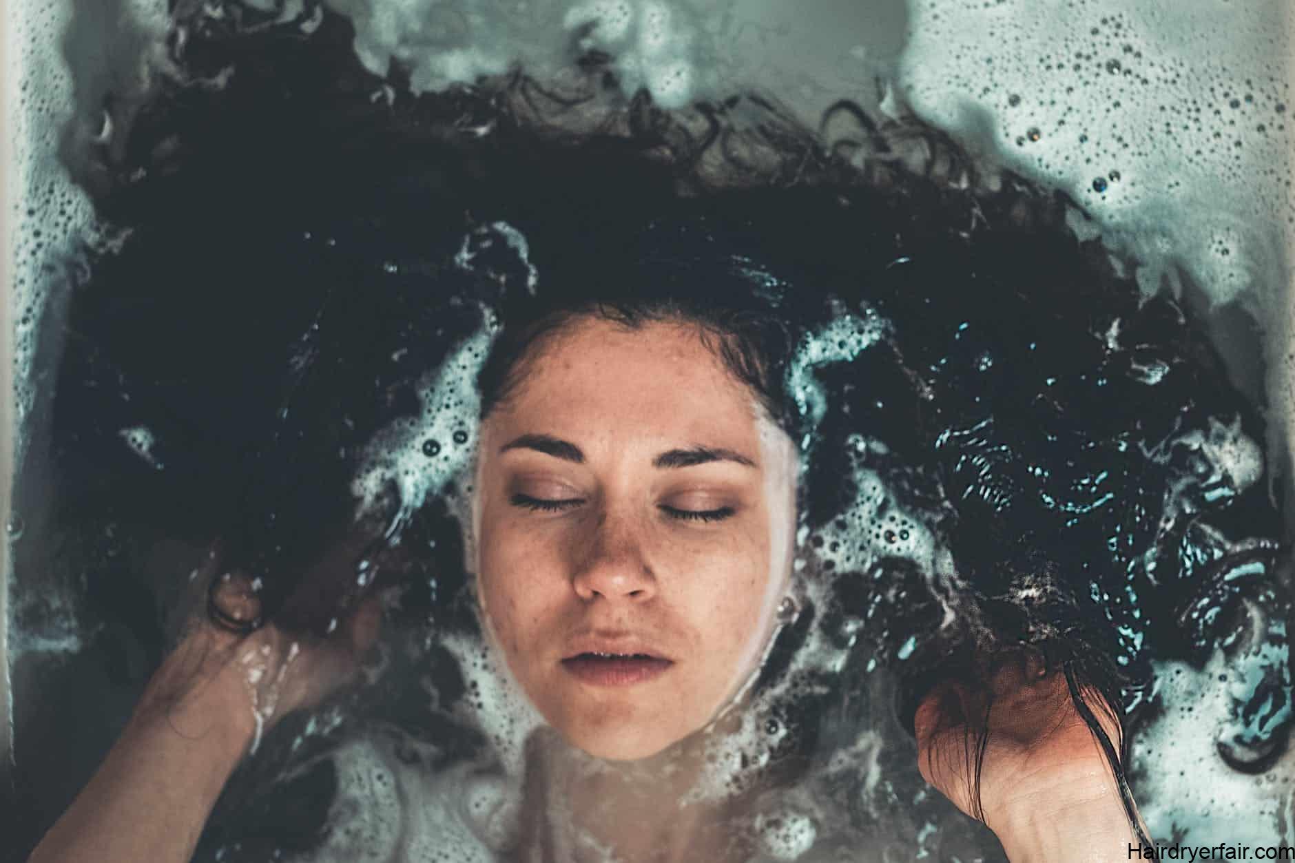 woman taking bath inside bathtub