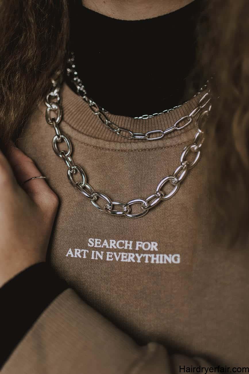 faceless stylish woman in chain necklace and sweatshirt