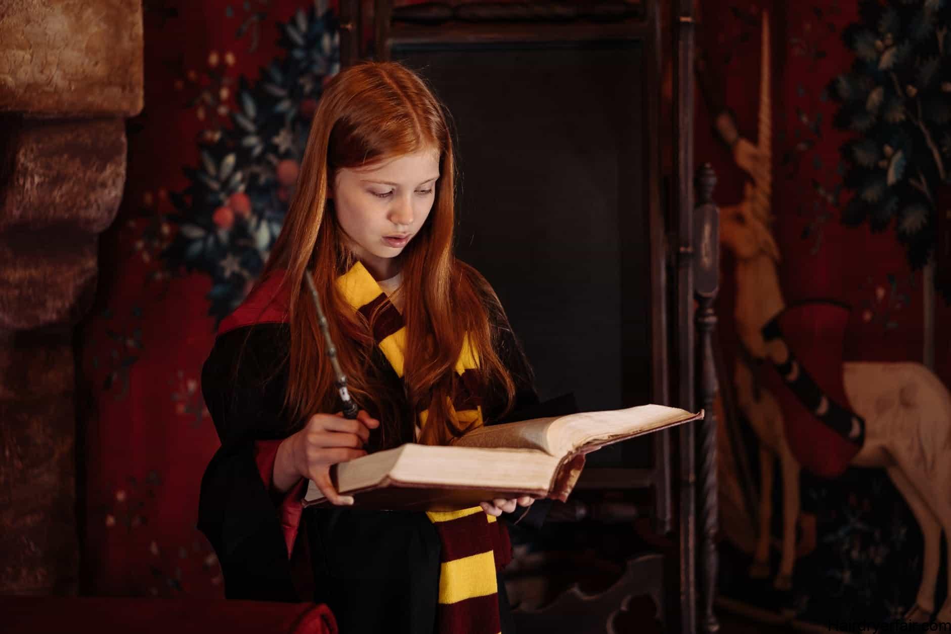 a young female wizard reading a book